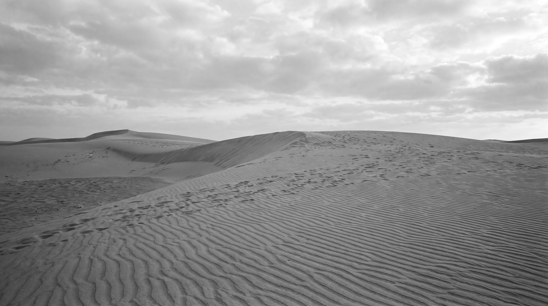Landscape: sand dunes under a clouded sky